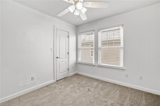 spare room featuring ceiling fan and light carpet