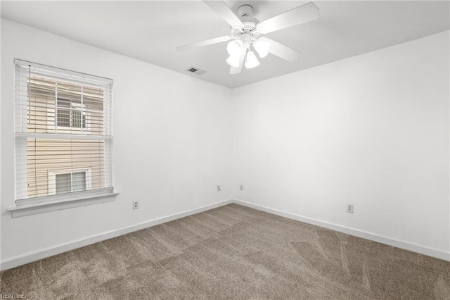 carpeted spare room with ceiling fan