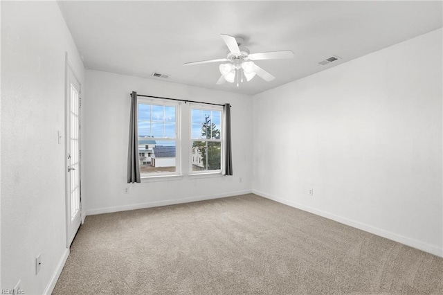 empty room featuring ceiling fan and carpet flooring