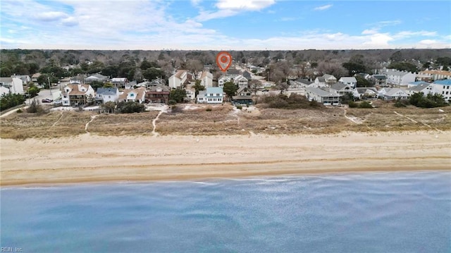 birds eye view of property featuring a view of the beach and a water view