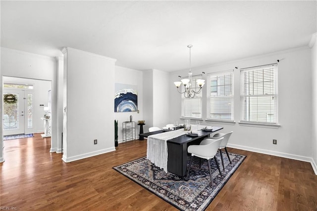 dining area with a notable chandelier, dark hardwood / wood-style flooring, and crown molding