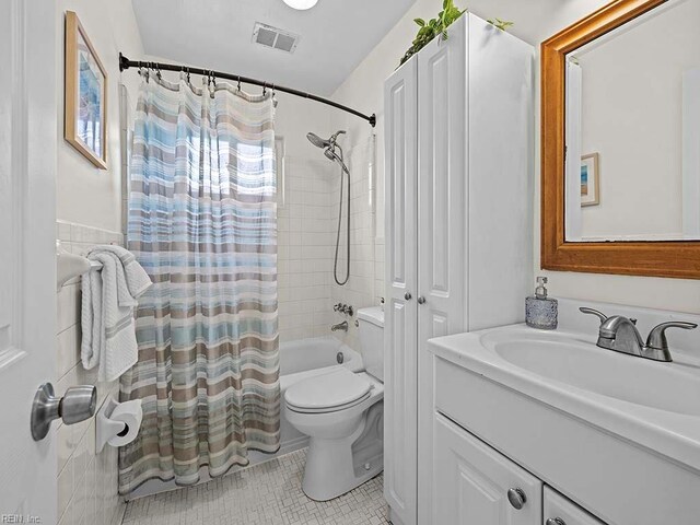 full bathroom with toilet, vanity, shower / bath combo, and tile patterned flooring