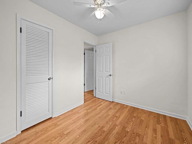 unfurnished bedroom featuring ceiling fan, a closet, and light hardwood / wood-style floors