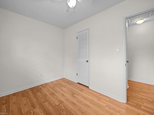 unfurnished bedroom with ceiling fan, a closet, and light hardwood / wood-style floors