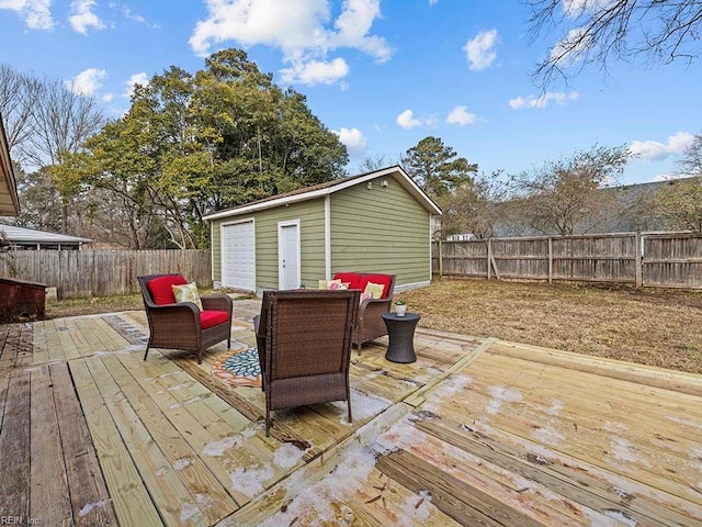 wooden deck with a garage and an outdoor structure