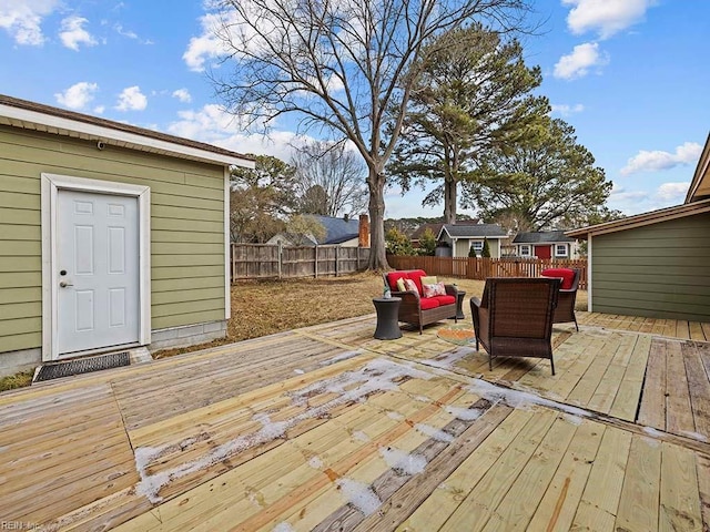 wooden terrace featuring an outdoor living space and a storage unit