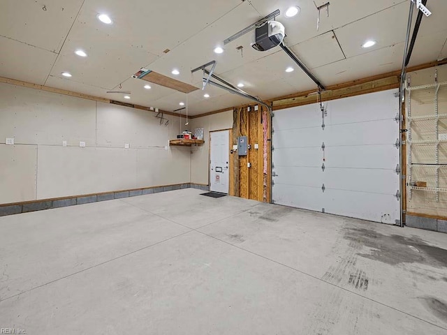 garage featuring electric panel and a garage door opener