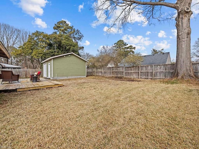 view of yard featuring a deck and an outdoor structure