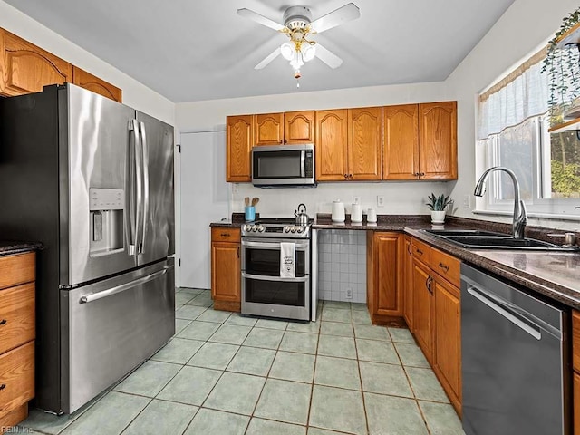 kitchen with light tile patterned floors, ceiling fan, stainless steel appliances, and sink