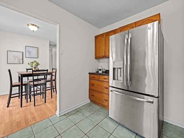 kitchen featuring stainless steel fridge and light tile patterned flooring