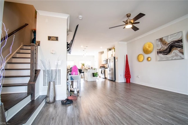 interior space with ceiling fan, crown molding, and dark hardwood / wood-style flooring