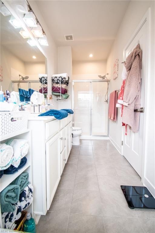 bathroom featuring toilet, an enclosed shower, and vanity