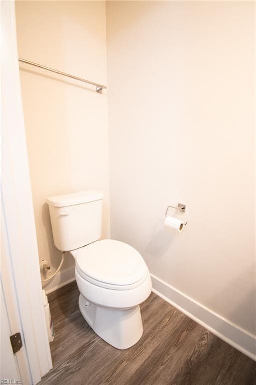 bathroom with toilet and wood-type flooring