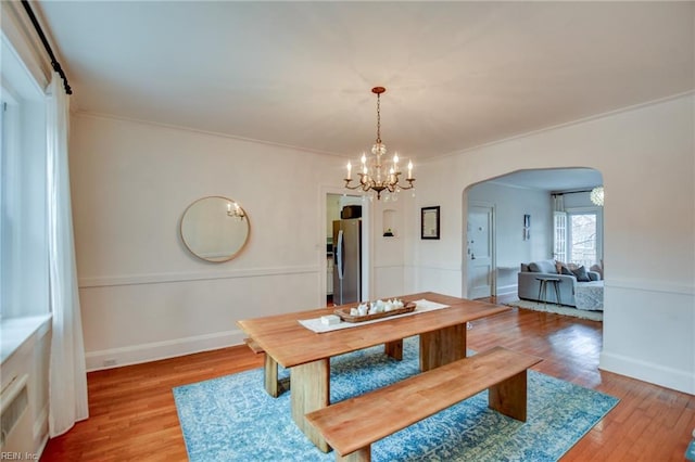 dining room with hardwood / wood-style floors and a notable chandelier