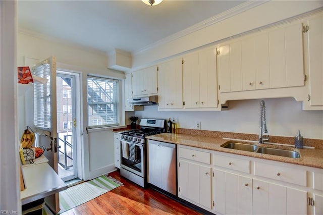 kitchen with dark wood-type flooring, stainless steel appliances, white cabinets, and sink