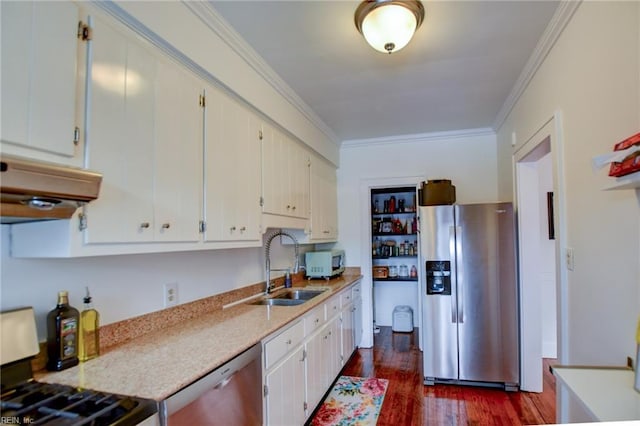 kitchen with appliances with stainless steel finishes, dark hardwood / wood-style flooring, ornamental molding, and white cabinetry