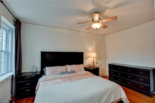 bedroom with ceiling fan and hardwood / wood-style floors