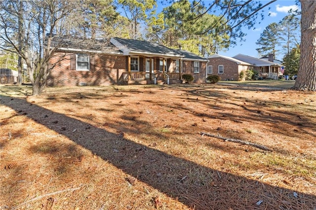 view of front of home with a front yard and a porch