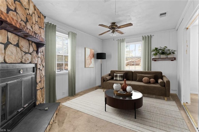 living room featuring light carpet, ceiling fan, and crown molding