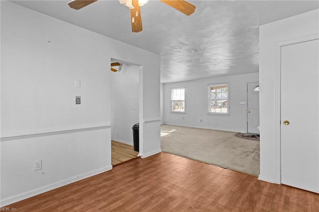 empty room with ceiling fan and light wood-type flooring