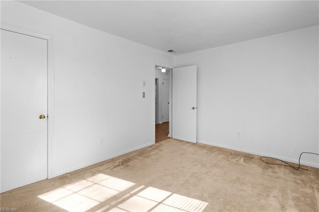 unfurnished bedroom featuring light carpet