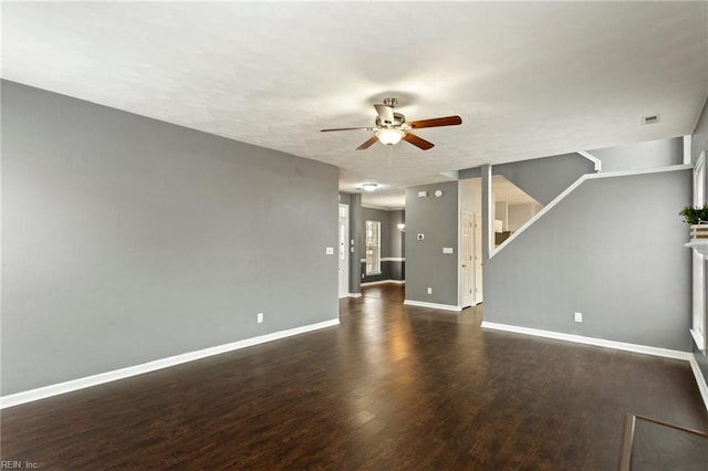 unfurnished living room with ceiling fan, dark hardwood / wood-style floors, and a fireplace