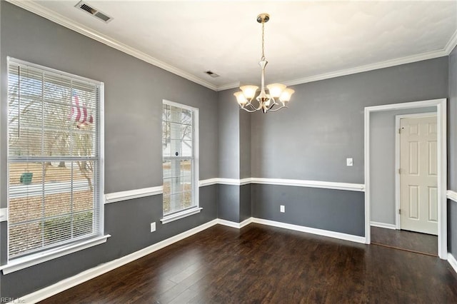 unfurnished dining area featuring dark hardwood / wood-style floors, crown molding, and a notable chandelier