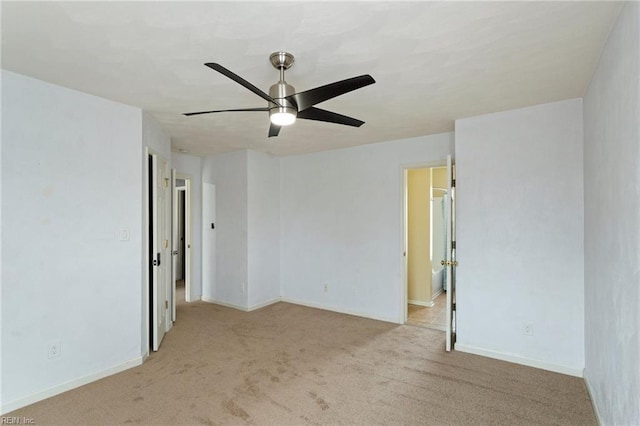 spare room featuring ceiling fan and light colored carpet