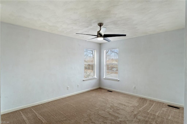 carpeted spare room with ceiling fan