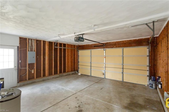 garage with a garage door opener and electric panel