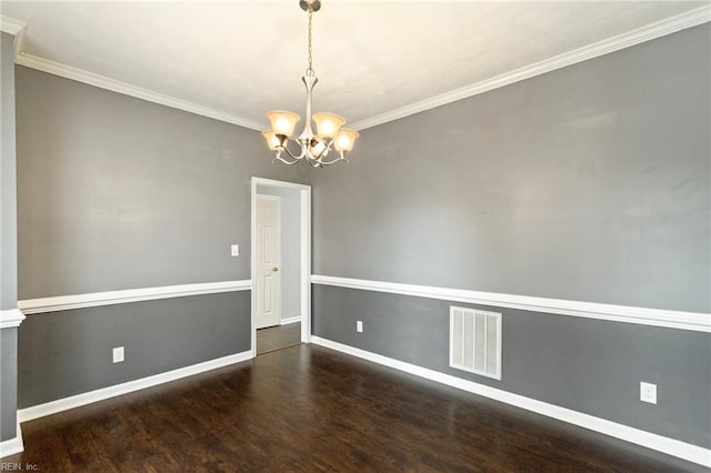 unfurnished room featuring dark hardwood / wood-style flooring, crown molding, and a chandelier