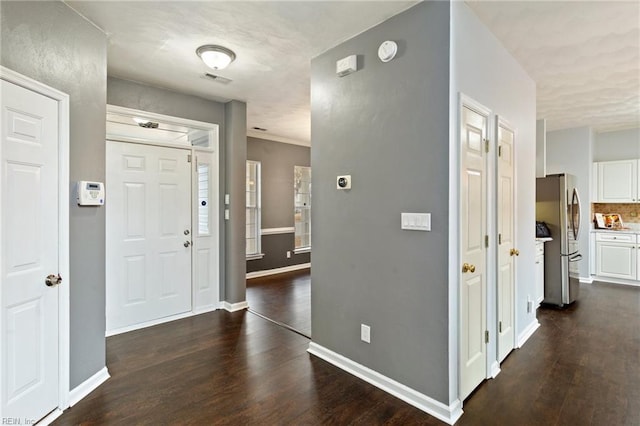 foyer entrance featuring dark wood-type flooring