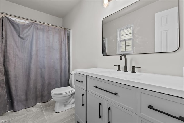 bathroom featuring toilet, tile patterned flooring, and vanity