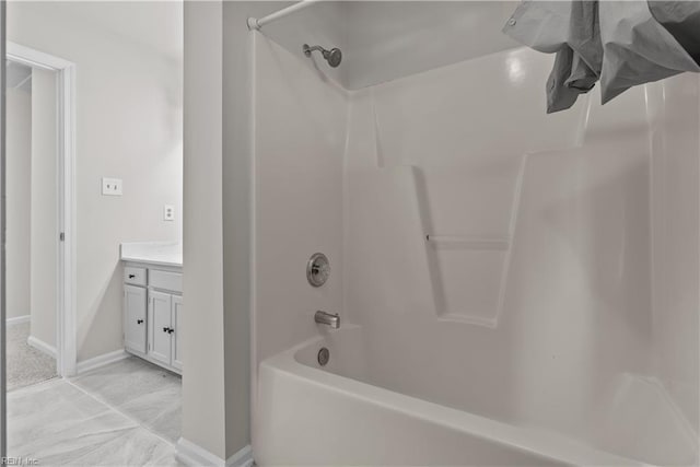 bathroom featuring vanity and  shower combination