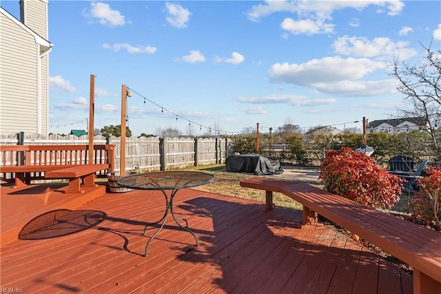 wooden deck featuring a grill