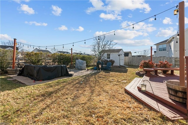 view of yard with a storage unit and a deck