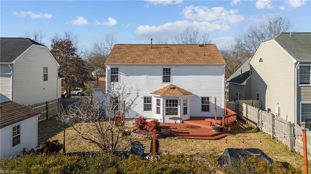 rear view of property featuring an outbuilding and a wooden deck