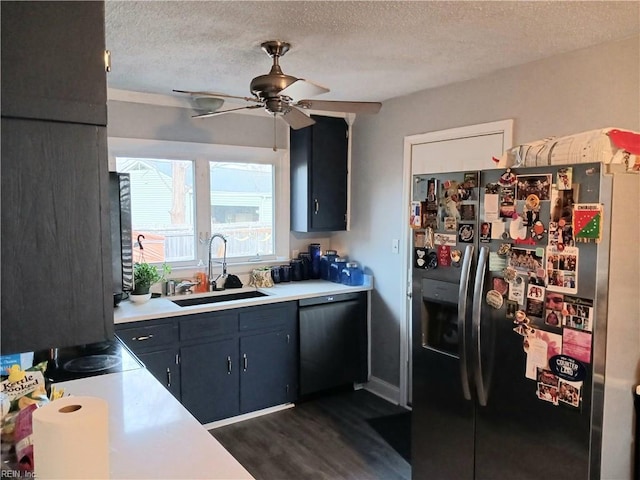 kitchen with a textured ceiling, black dishwasher, sink, stainless steel fridge, and ceiling fan