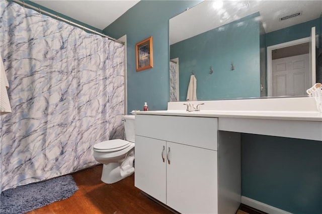 bathroom with hardwood / wood-style flooring, toilet, vanity, and a shower with shower curtain