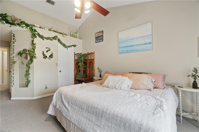 bedroom with ceiling fan, light colored carpet, and vaulted ceiling