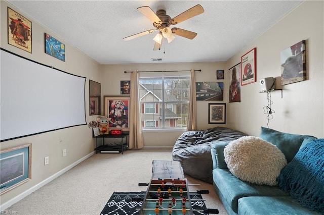 cinema room featuring carpet floors and ceiling fan