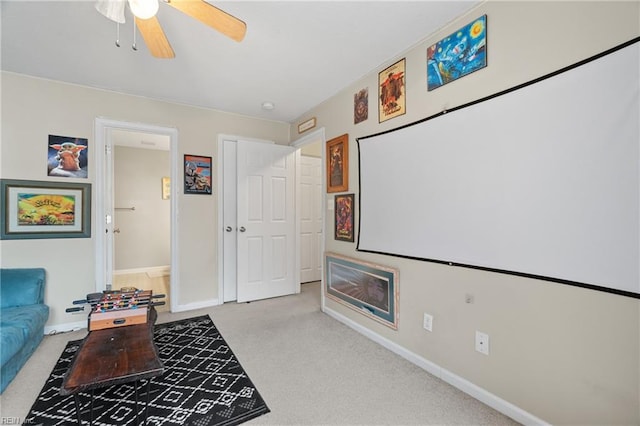 interior space with ceiling fan and light colored carpet