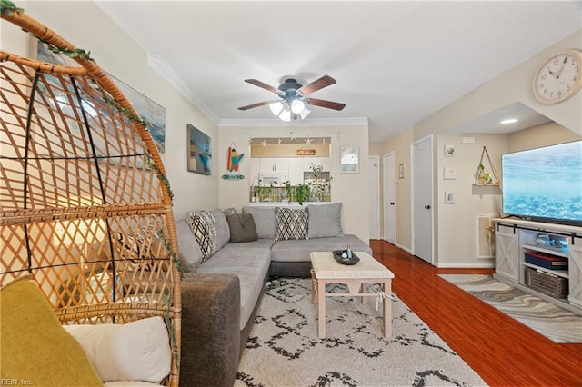 living room featuring ceiling fan, hardwood / wood-style floors, and crown molding