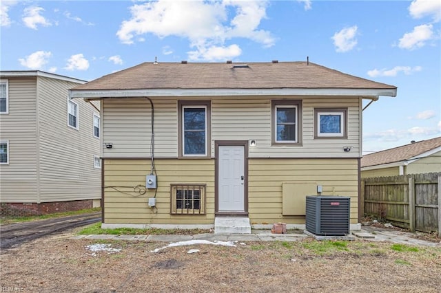 rear view of house with central AC unit