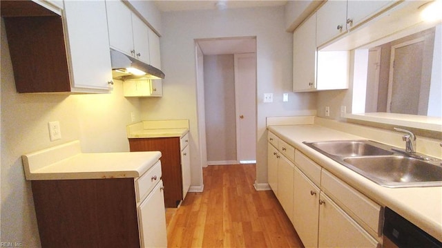 kitchen with light hardwood / wood-style flooring, stainless steel dishwasher, white cabinets, and sink