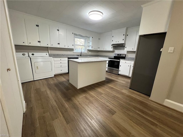 kitchen featuring washer and dryer, appliances with stainless steel finishes, a kitchen island, white cabinetry, and dark hardwood / wood-style flooring