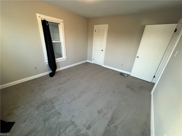 unfurnished bedroom with a closet and carpet flooring