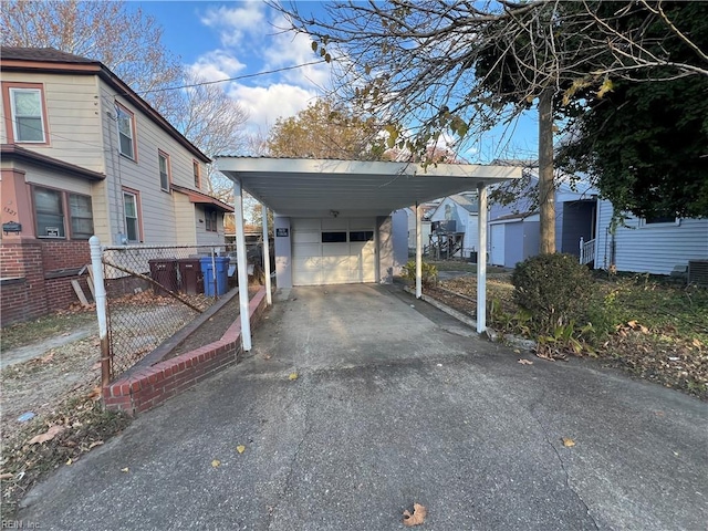 view of vehicle parking featuring a garage and a carport