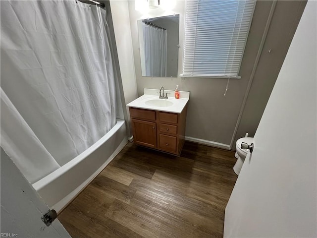 full bathroom with shower / bath combo with shower curtain, wood-type flooring, toilet, and vanity