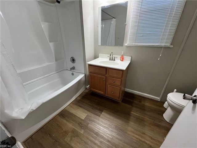 full bathroom featuring toilet, shower / bath combo, hardwood / wood-style floors, and vanity